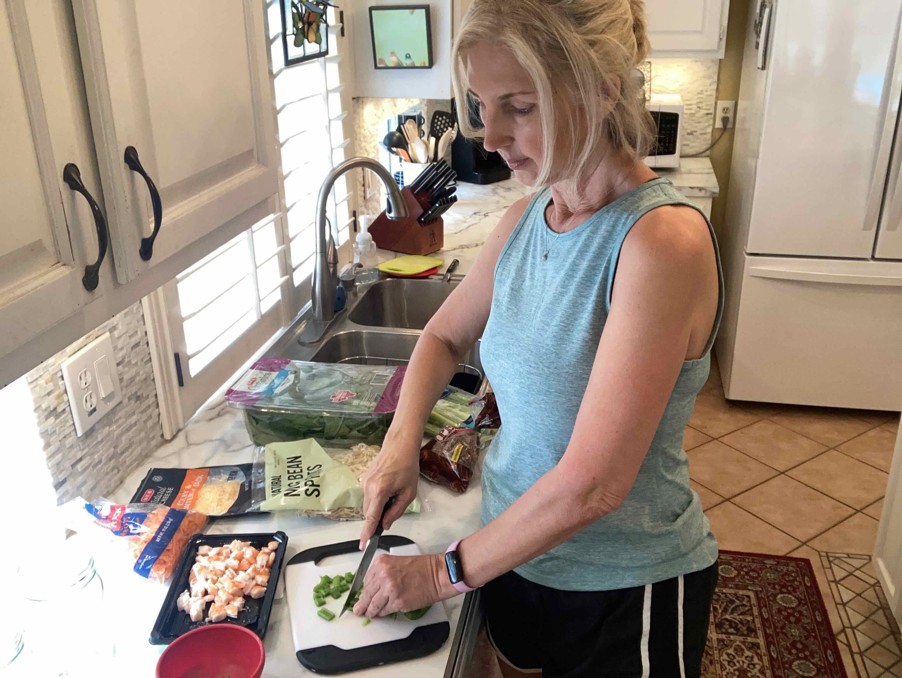 Courtenay Rudzinski in kitchen chopping vegetables