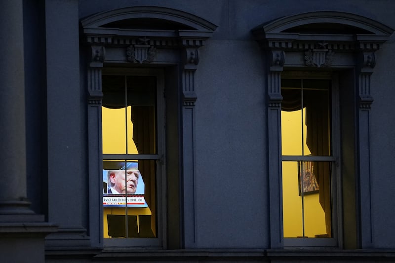 A news report on the attempted assassination on Republican presidential candidate and former U.S. President Donald Trump at a rally in Butler, Pennsylvania, plays on a TV screen at the Eisenhower Executive Office Building in Washington, U.S., July 14, 2024. REUTERS/Nathan Howard
