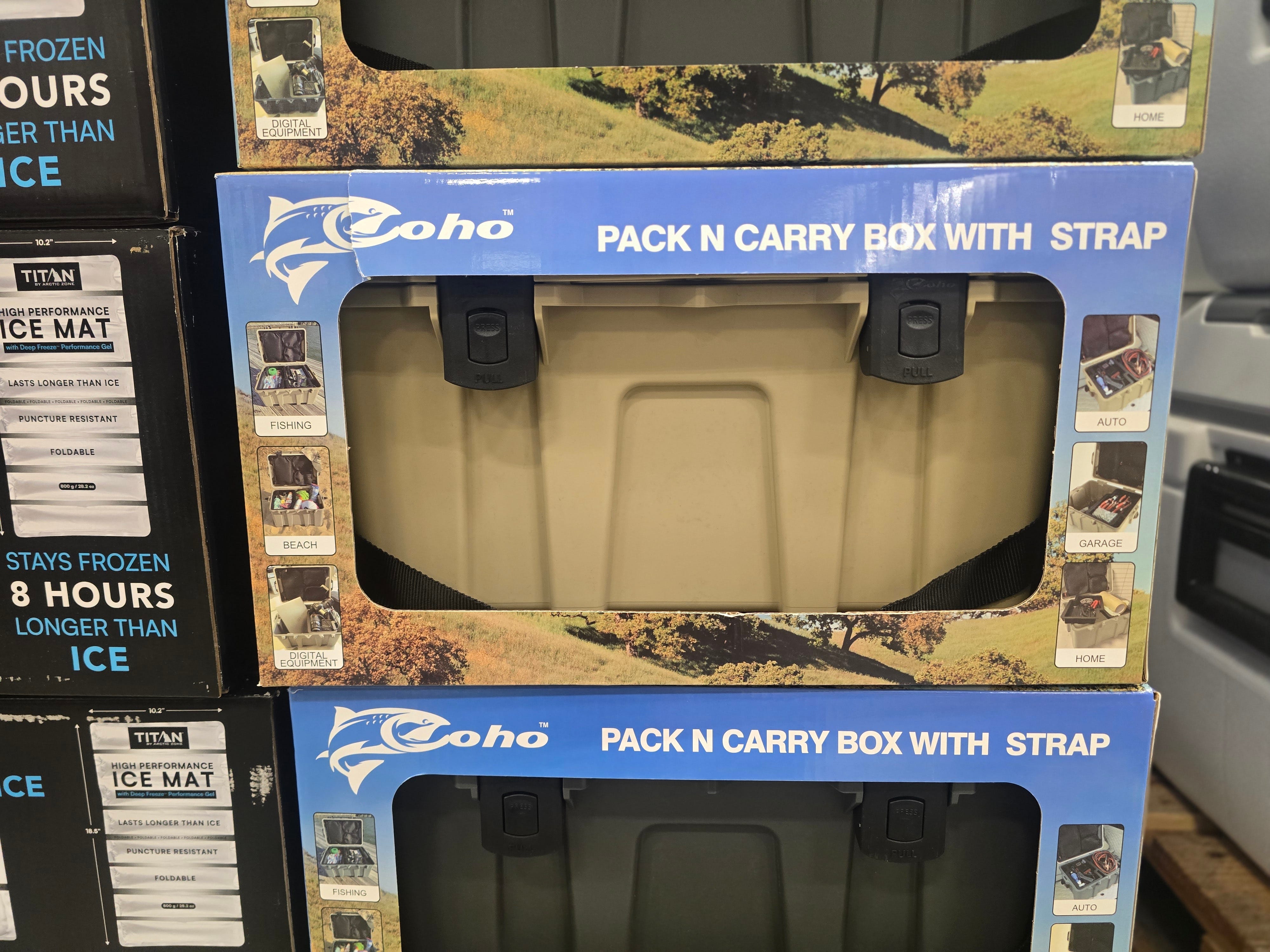 Boxes of carrying cases in beige and black colors.