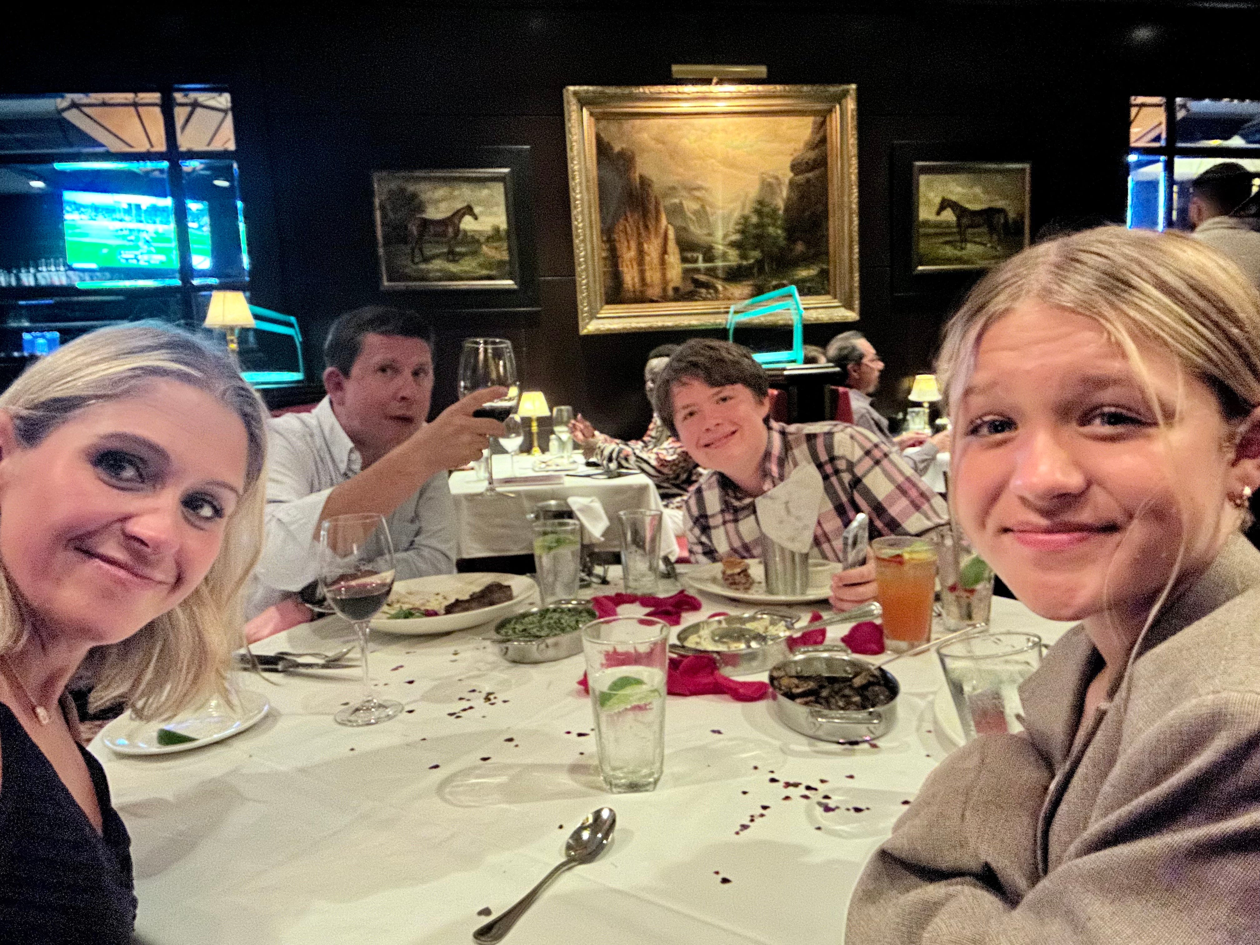 Terri Peters and her family smiling at Capital Grille