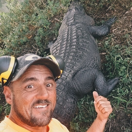 Jeremy Dufrene next to an alligator 
