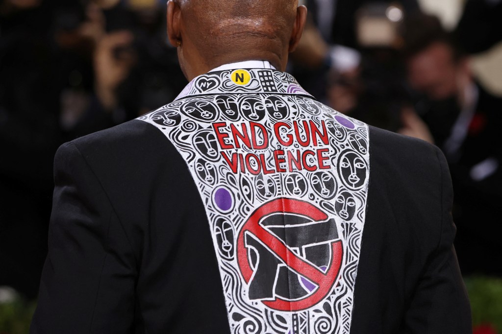 The back of New York City Mayor Eric Adams tuxedo features an anti-gun graphic on the back.