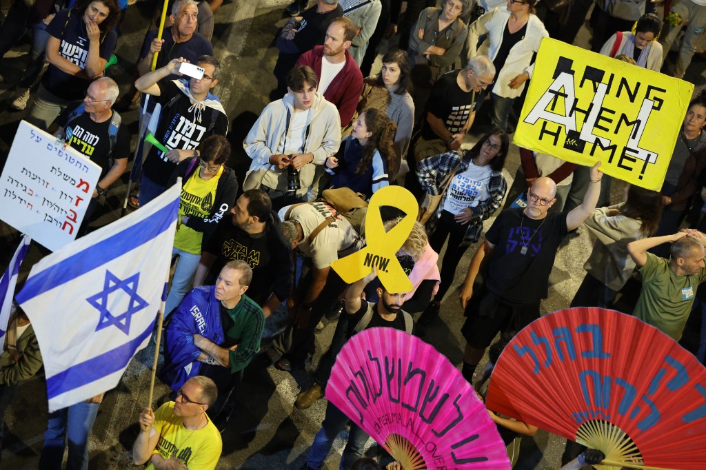 Demonstrators holding placards during a protest outside the Israeli Defence Ministry in Tel Aviv, demanding the release of Israeli hostages in the Gaza Strip, 2025.