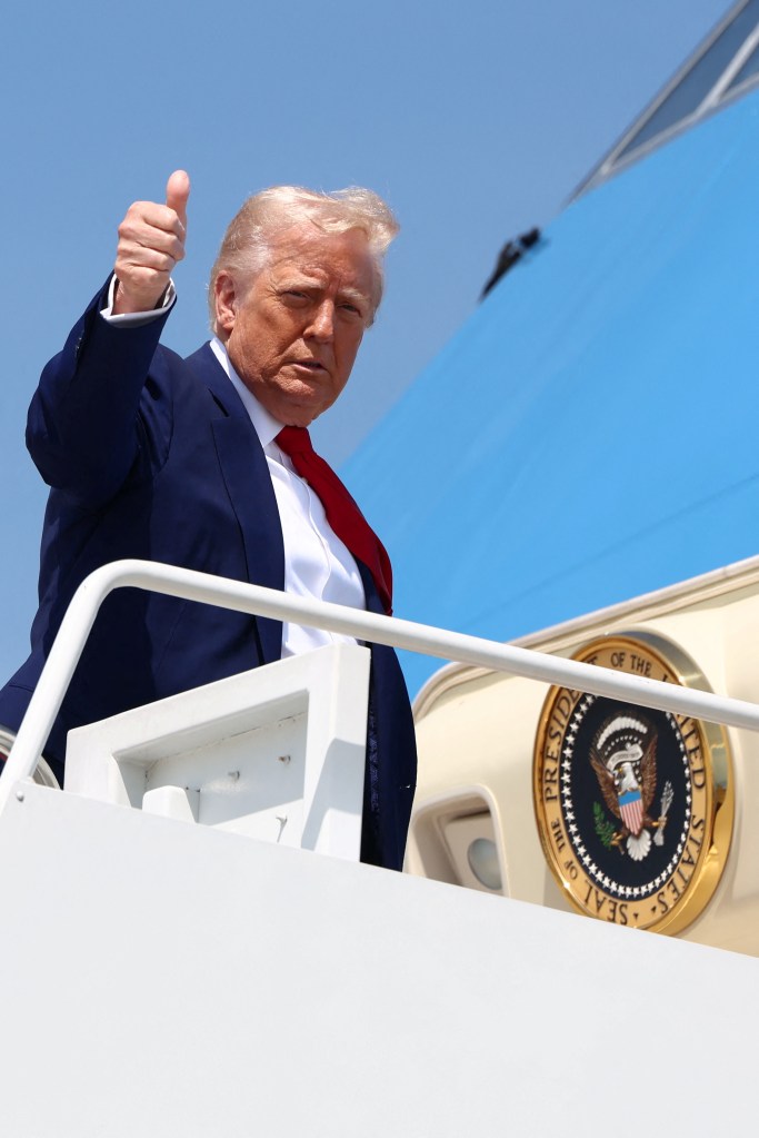 President Donald Trump boarding Air Force One at Joint Base Andrews, about to depart for a rally in Michigan, celebrating his first 100 days in office.