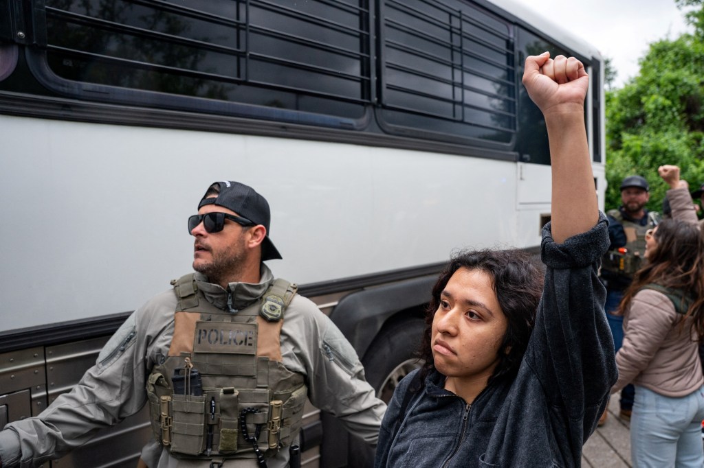 An immigration protester is detained by an ICE agent during the rally against the DHS in Nashville.