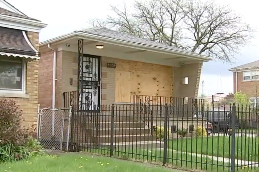 The South Side home with boards blocking up the front windows.