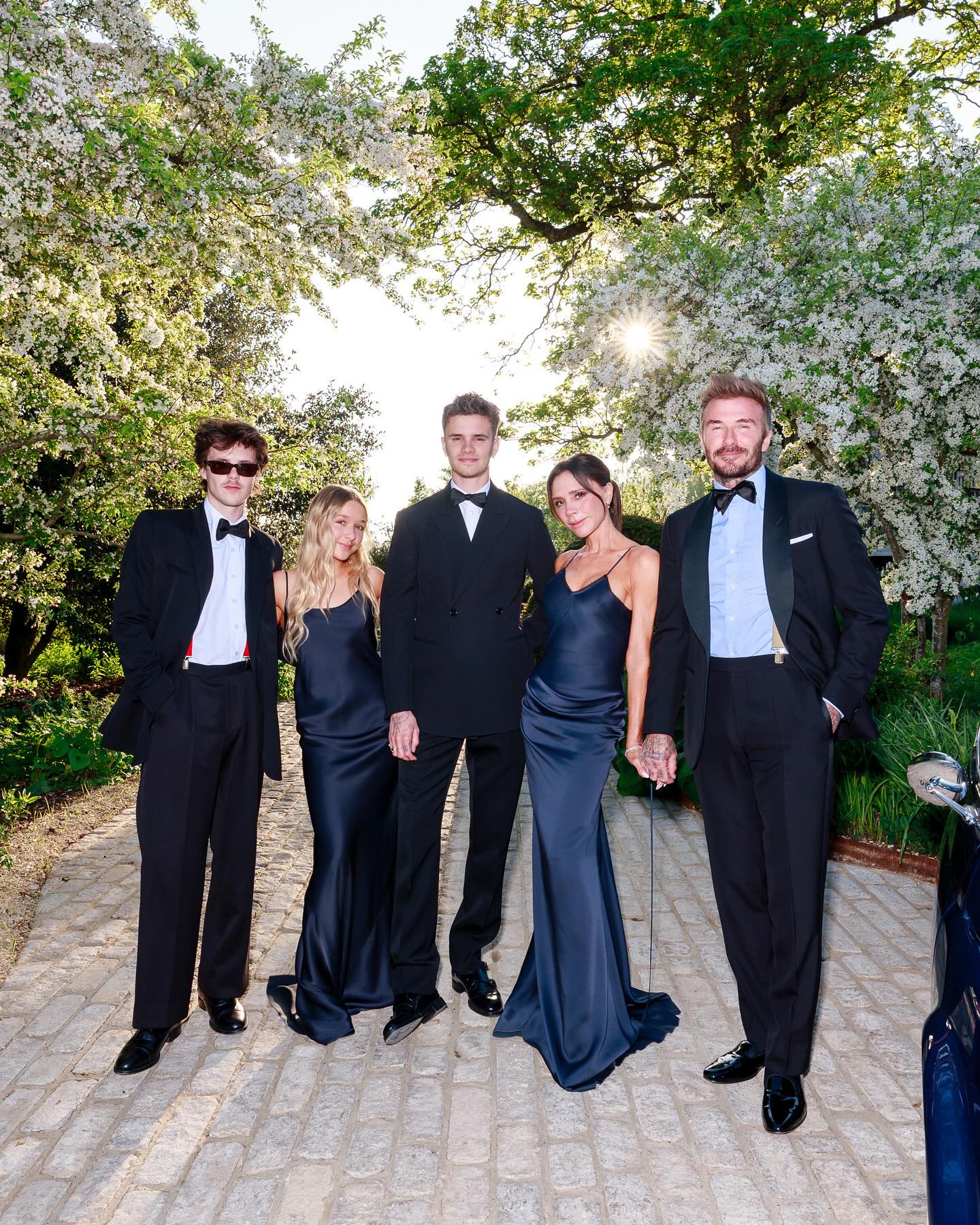 The Beckham family posing for a photo in black tie.
