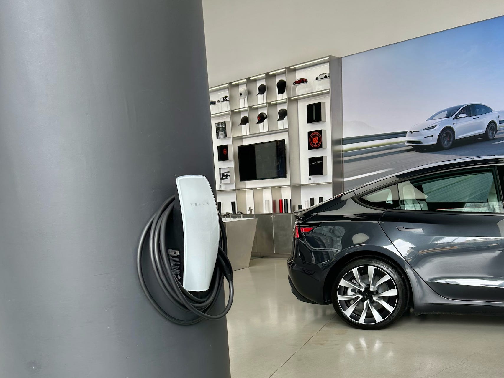 Tesla charger on a wall in a New York City showroom.