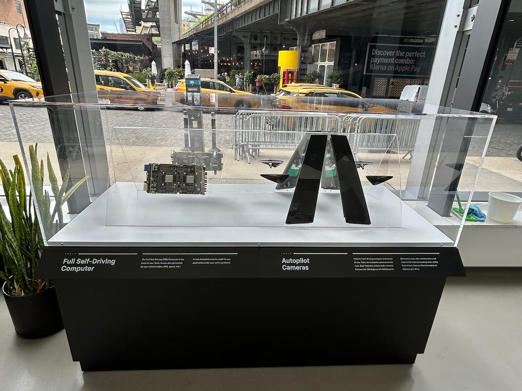 Tesla Full Self-Driving Computer and Autopilot Camera station at a showroom in Manhattan
