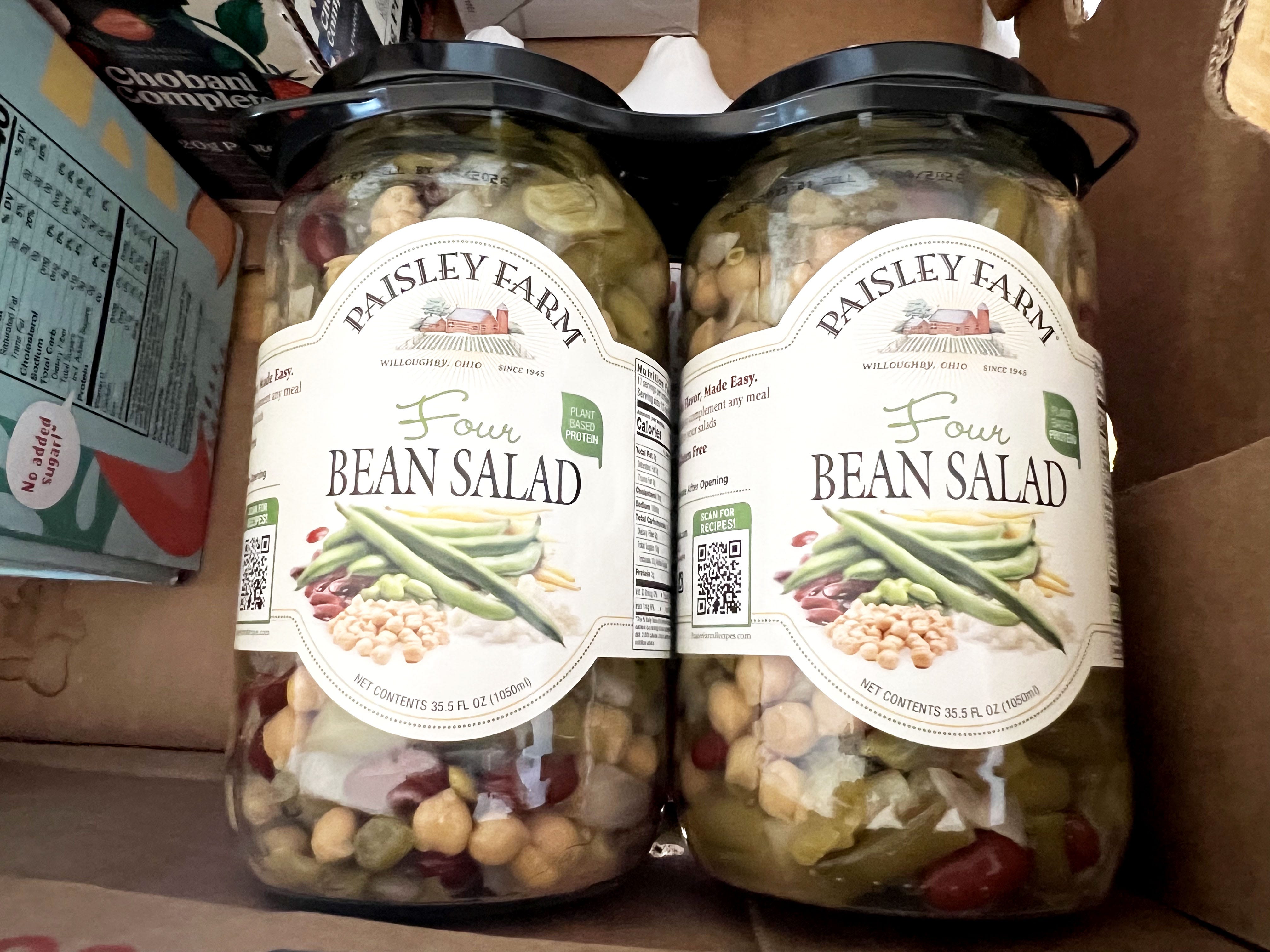 Jars of Paisley Farm four-bean salad in a box with other products.