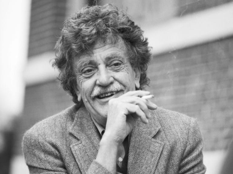 View of American author Kurt Vonnegut Jr (1922 - 2007) as he smokes a cigarette outside the Michigan State University Student Union, East Lansing, Michigan, April 9, 1992