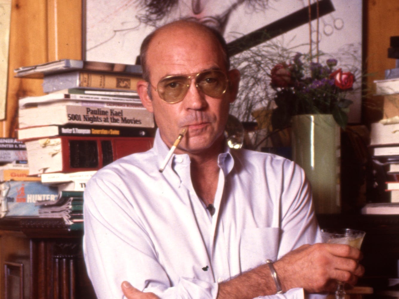 Hunter Thompson aka Hunter S Thompson aka Gonzo Journalist at his ranch standing against a bookcase