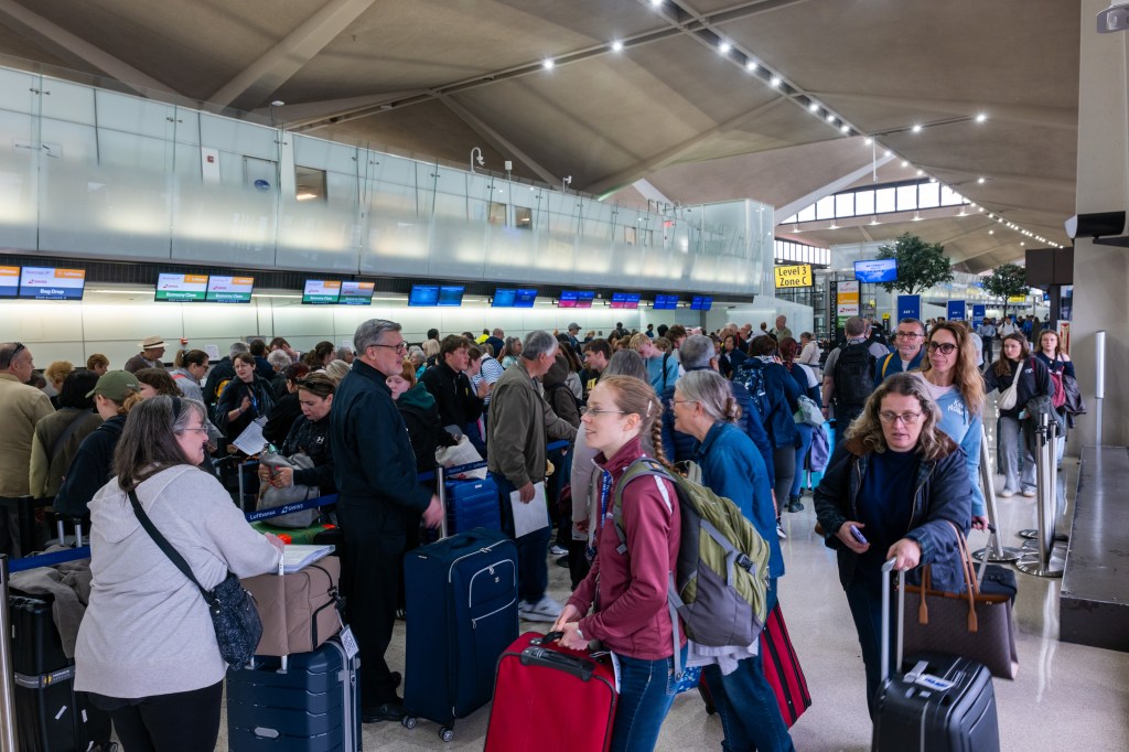 People wait in line for a delayed flight at Newark International Airport on May 05, 2025 in Newark, New Jersey.