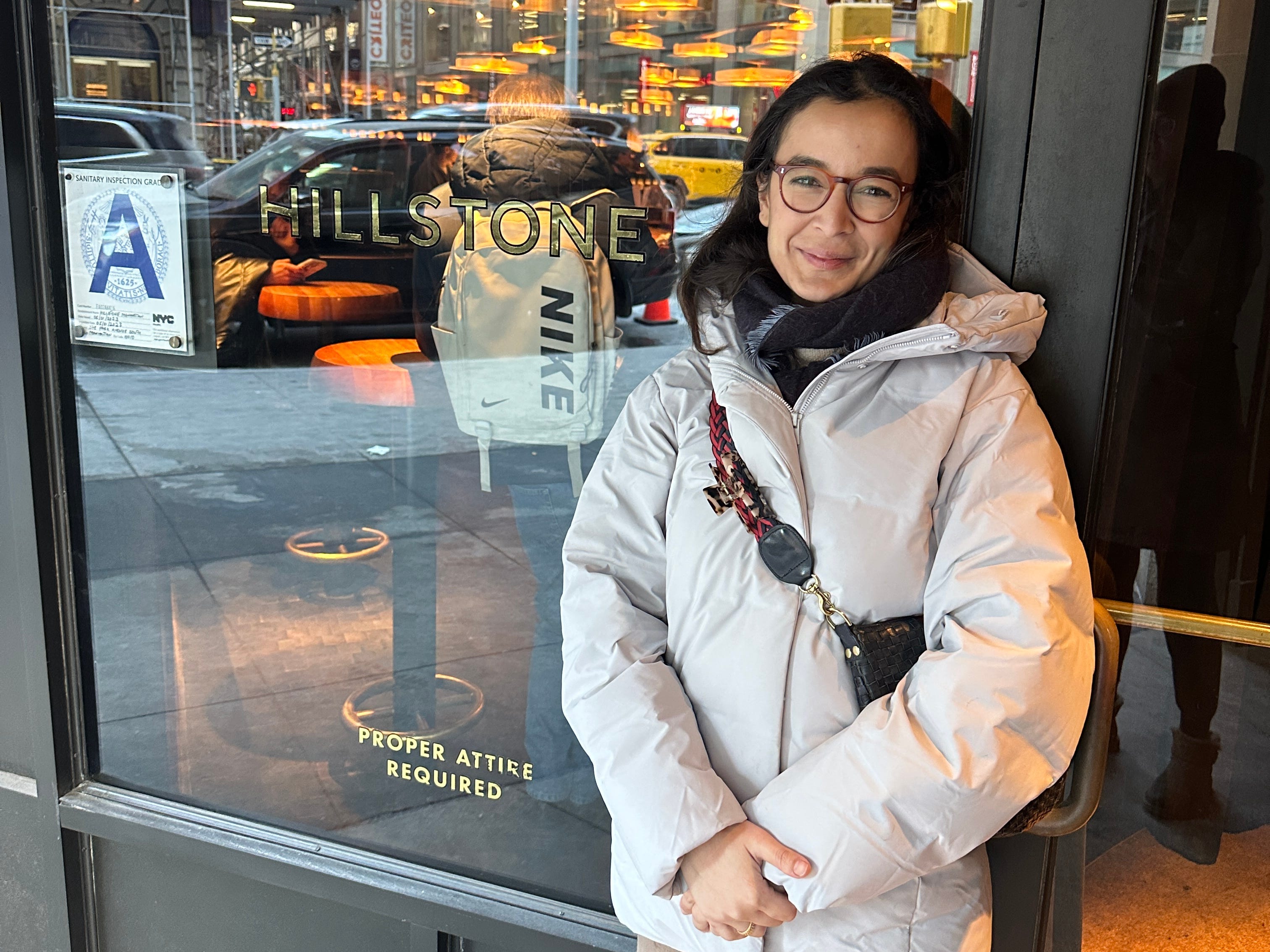 Fatima poses in front of the exterior of the Hillstone NYC restaurant.