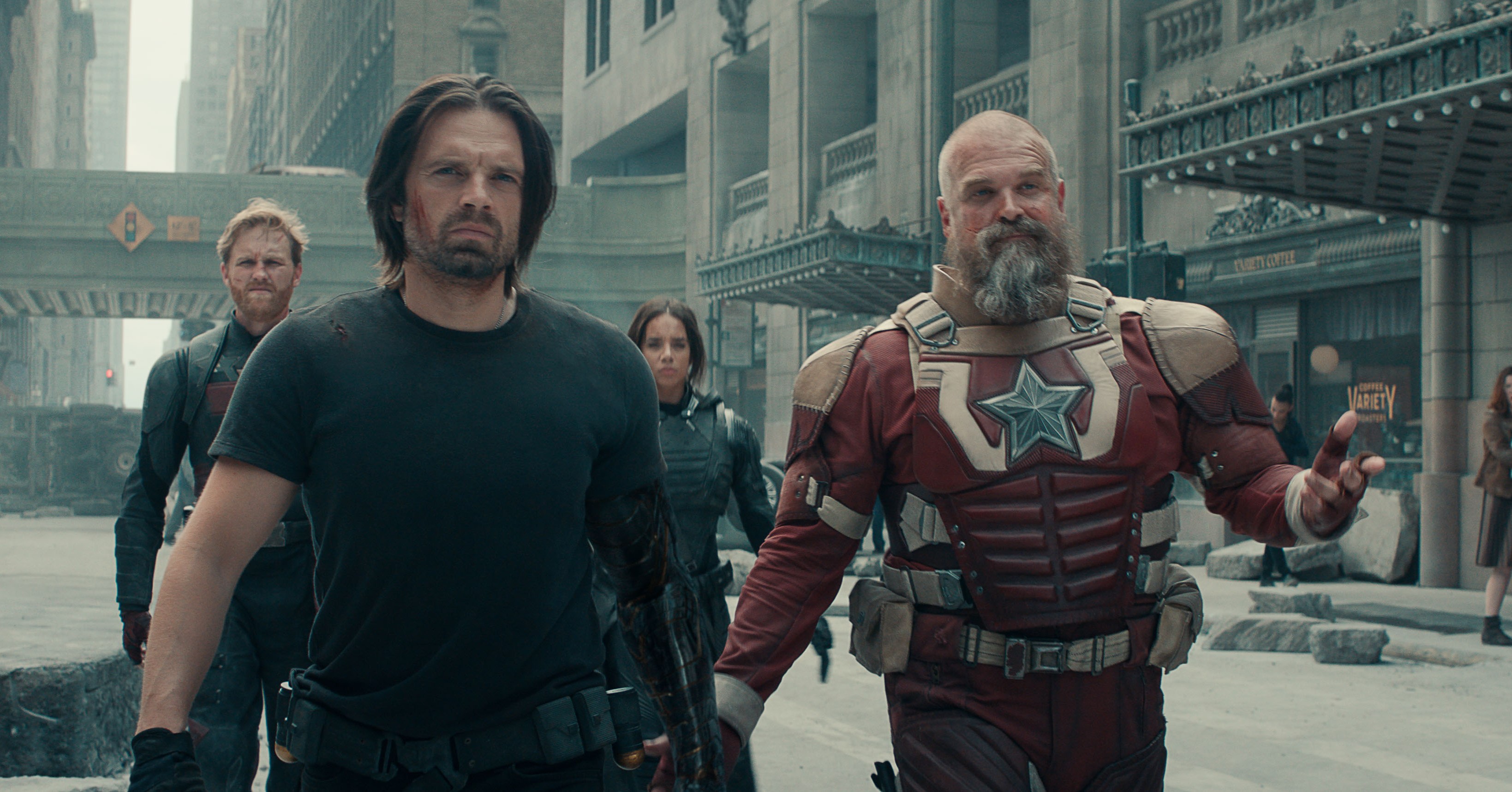 Bucky (Sebastian Stan), Red Guardian (David Harbour) and the other members of the Thunderbolts walk toward the camera on a rubble-strewn Manhattan street in Thunderbolts*