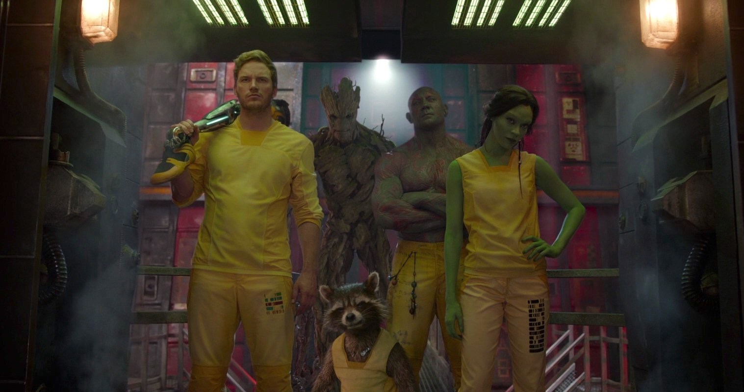 the cast of guardians of the galaxy in yellow prison jump suits