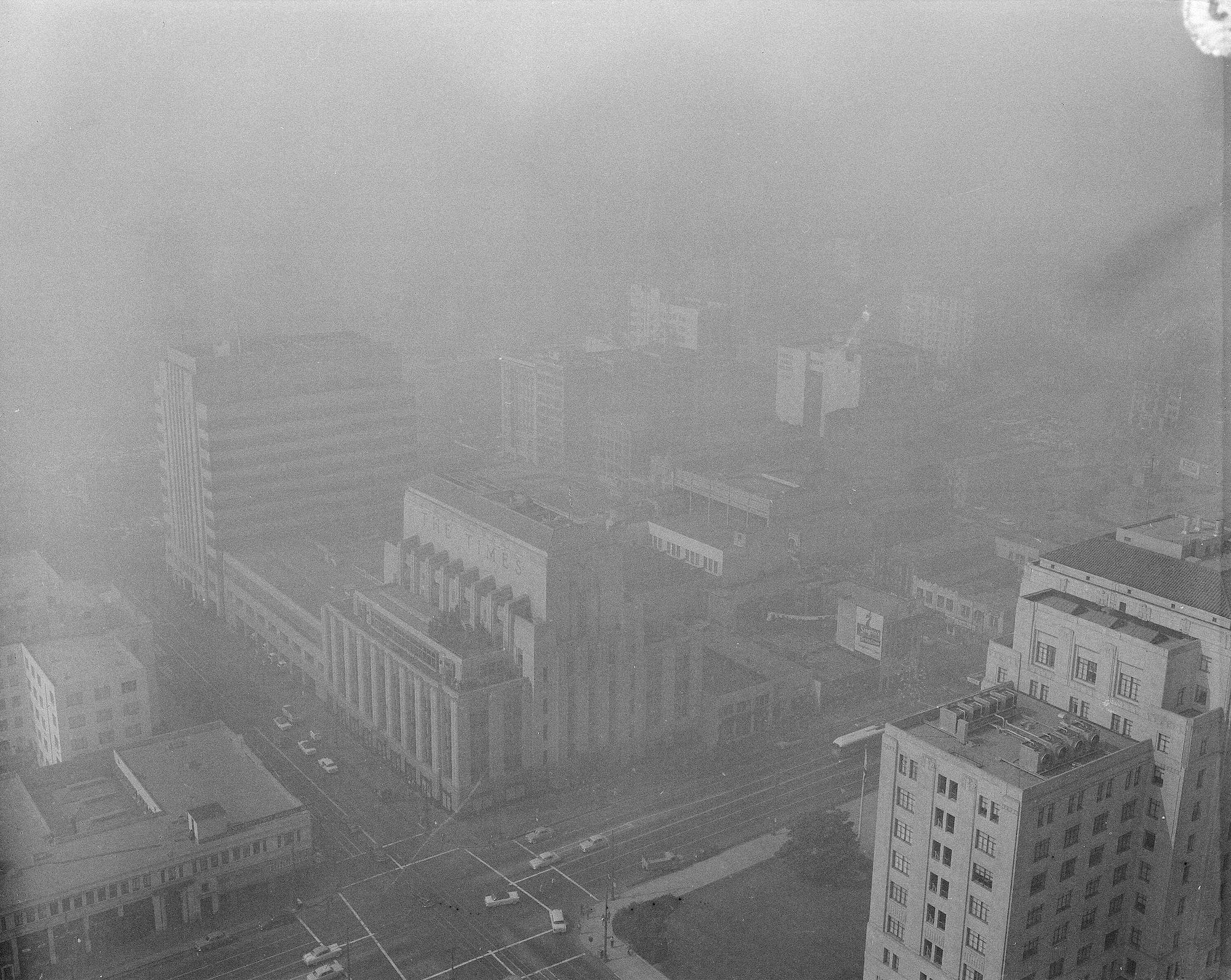 This is the view, if you can call it that, from the Los Angeles City Hall, Oct. 14, 1954, during the eighth day of an eye-piercing, lung congesting smog that has brought angry protests from citizens demanding that somebody do something about it. Barely visible are the Times and Mirror Buildings a block away, with the rest of the downtown business section completely obscured.