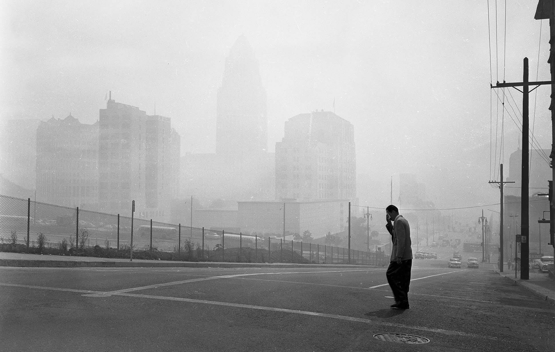 Buildings in Los Angeles Civic Center are barely visible in picture looking east at 1st and Olive Sts. at 11 a.m. when smog was at its peak. Visible buldings from left are Hall of Records, Law Building, new County Law Library, State Building, with City Hall faded in background. This photo was published in the Sep. 14, 1955
