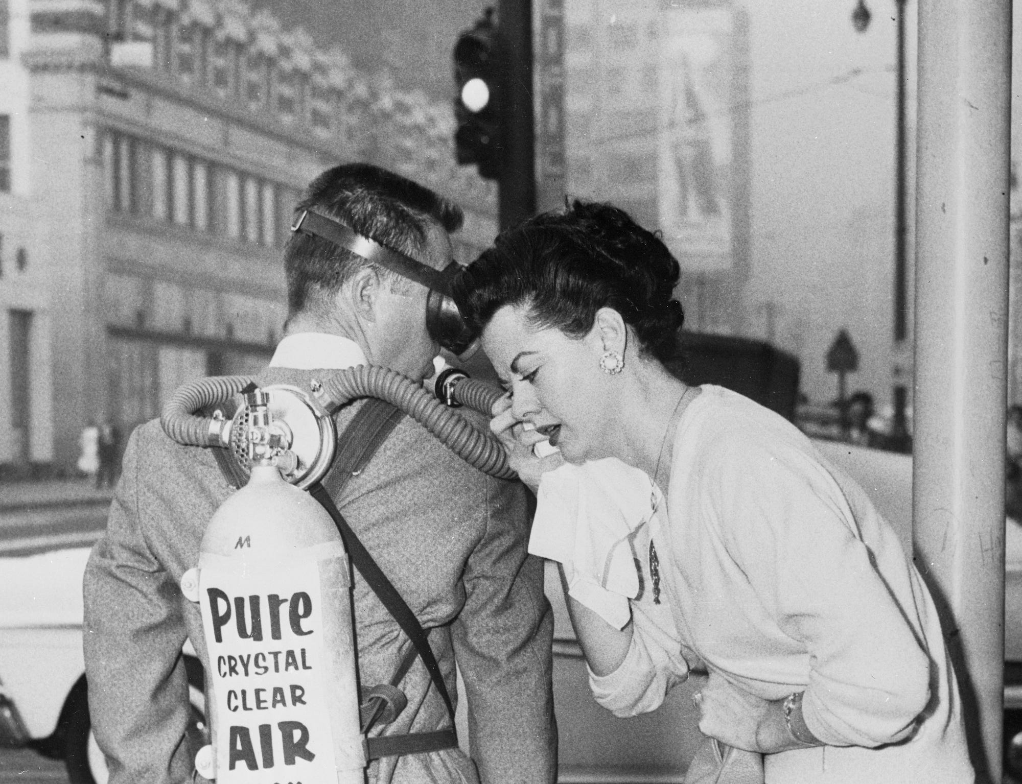 Mariellen Morgan wipes away the tears as she is about to get some smog relief from Hank McCullough of West Hollywood. McCullough was a member of a small "task force" that brought in "fresh air" from outside Los Angeles November 25th as eye-irritating smog tormented residents for the third day in a row.
