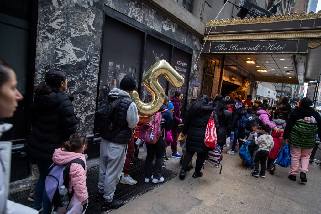 Migrants outsde the Roosevelt.