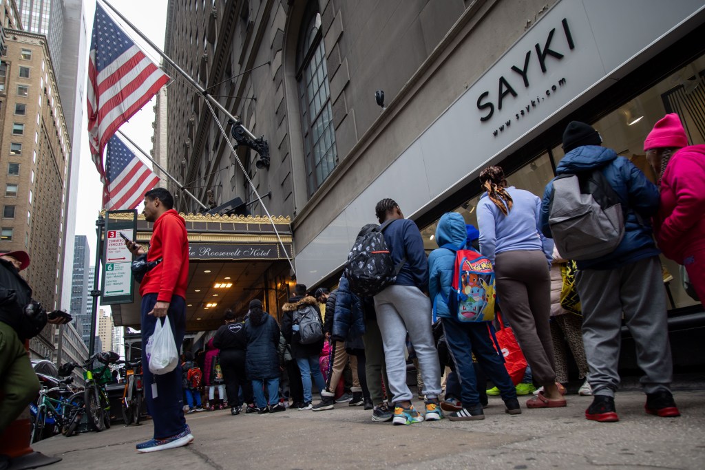 Migrants outside the Roosevelt.