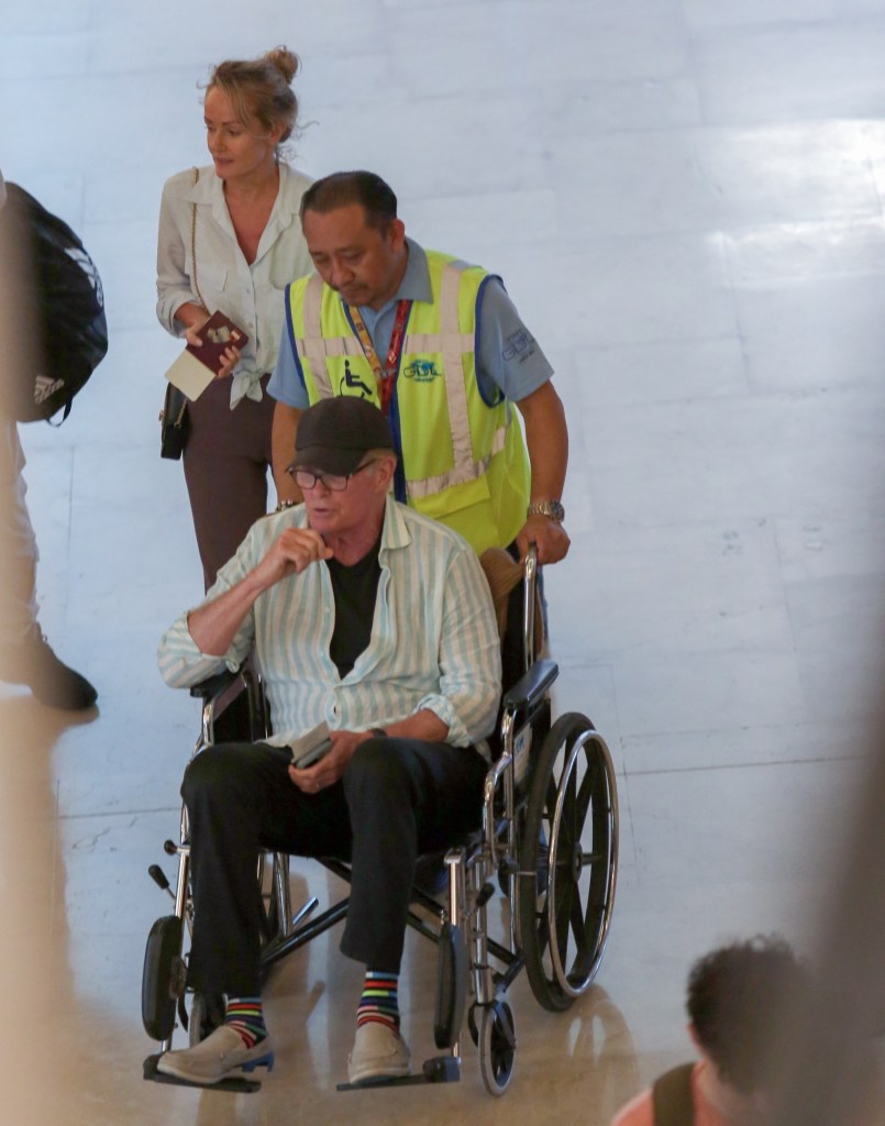David Hasselhoff gets a helping hand in a wheelchair as he and Hayley Roberts wrap up their sun-soaked getaway in Cancun, Mexico.