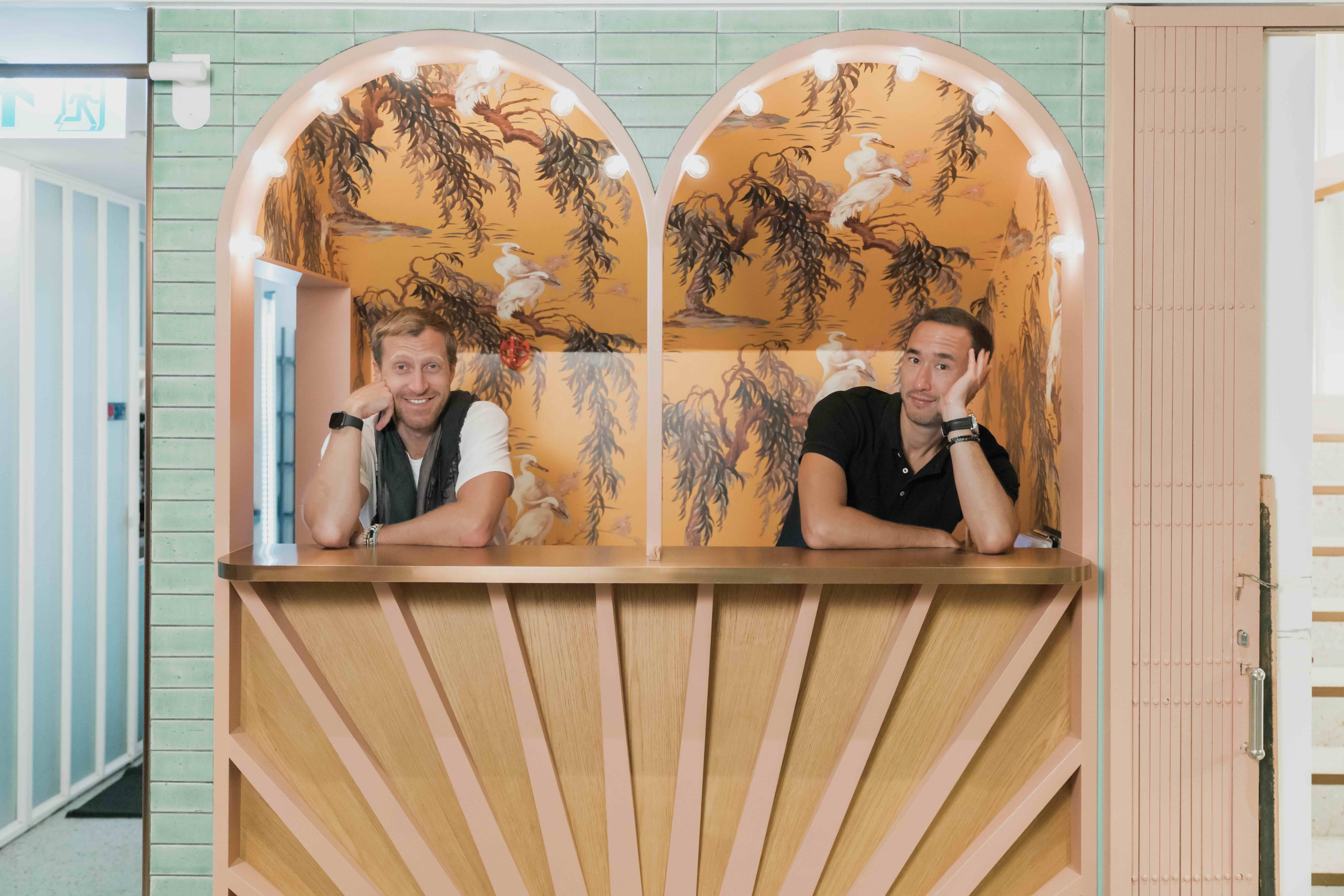 Malcolm Wood and Matt Reid posing behind a bar.