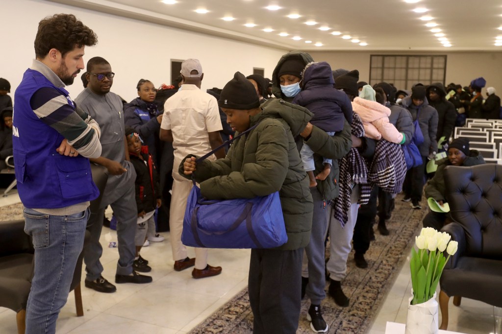 Group of over 170 Nigerian migrants waiting to board buses for deportation at the offices of the department of combating illegal migration, headed to Tripoli's Mitiga International Airport.