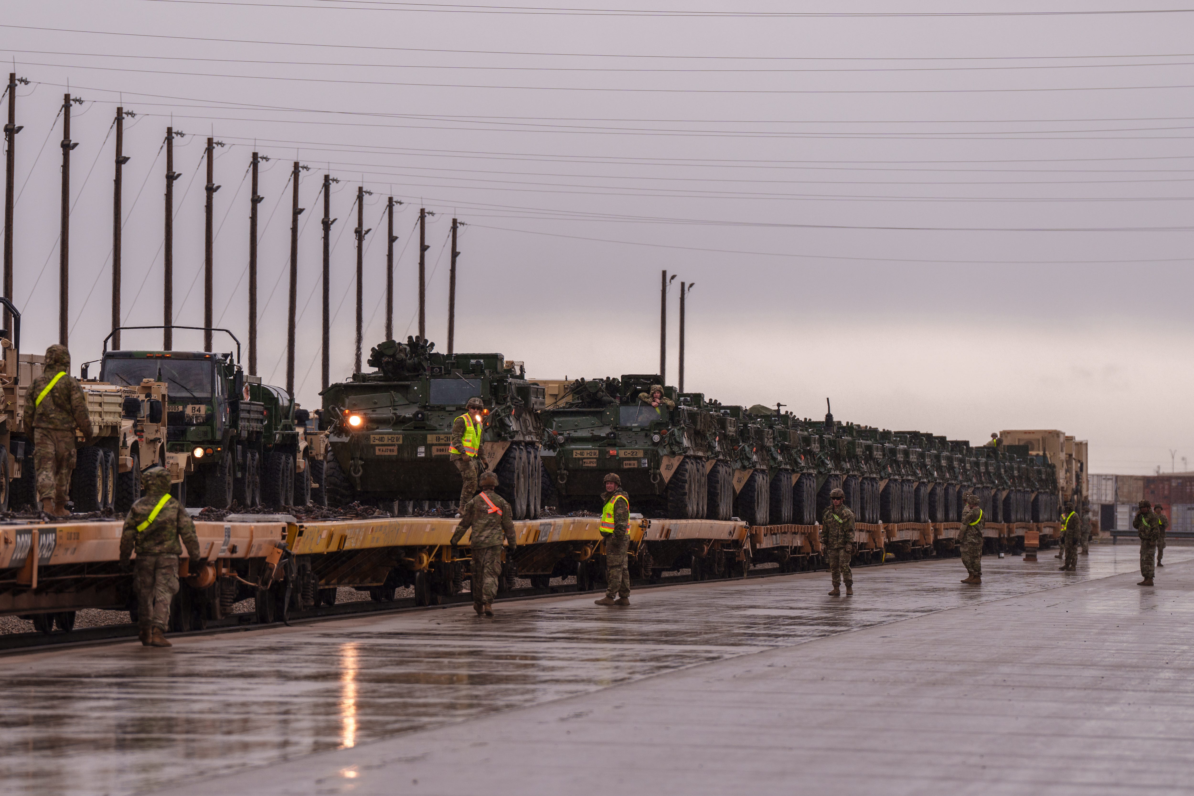 US Army soldiers unload Stryker armored infantry transport vehicles.