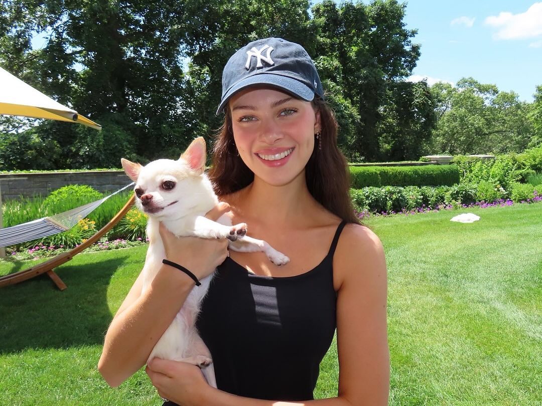 Nicola Peltz holds up her pooch for a pic.