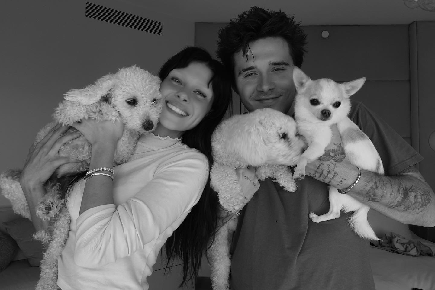 Brooklyn Beckham and Nicola Peltz hold dogs in a sweet picture.