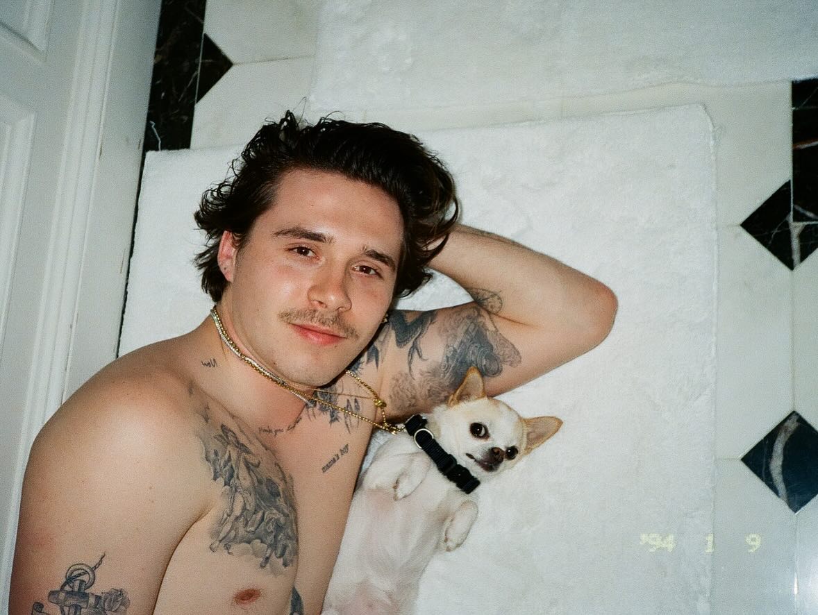 Brooklyn Beckham poses with his late pooch.