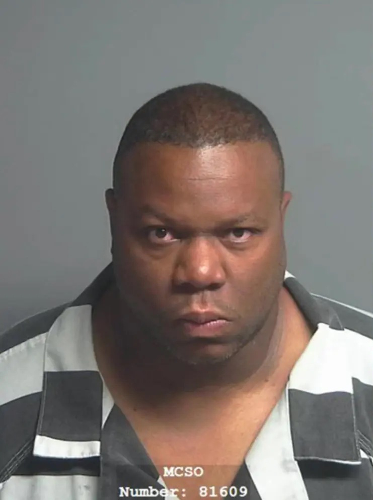Former NFL player Kevin Ware Jr. stares at the camera in a mugshot taken by the Harris County Sheriff's Office.