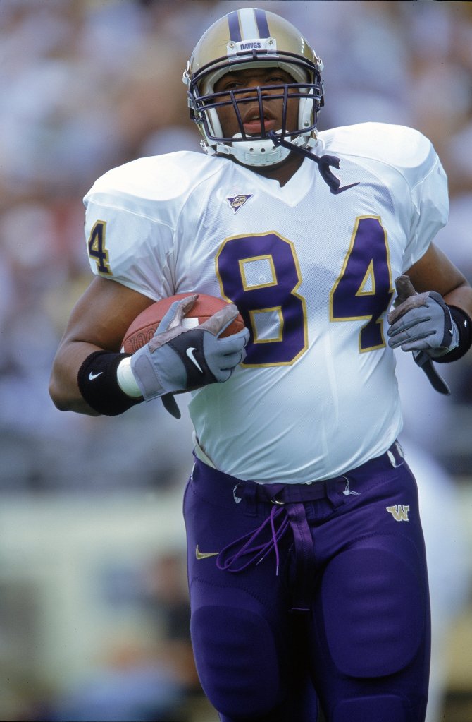 Ware carries the ball during a game for the Washington Huskies against the Oregon Ducks on Sept. 30, 2000.