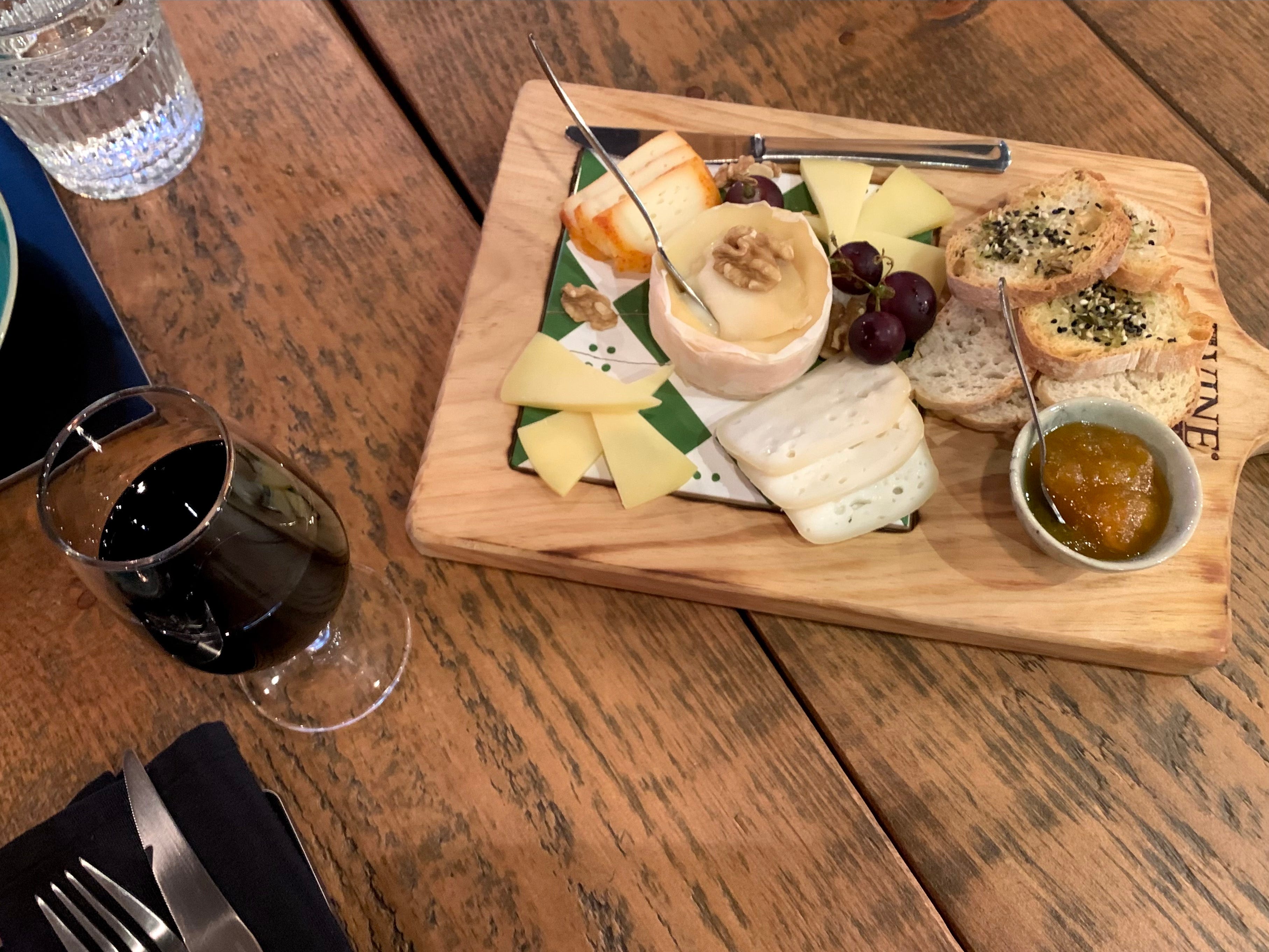A charcuterie board and glass of red wine at The Wine Box in Porto, Portugal.