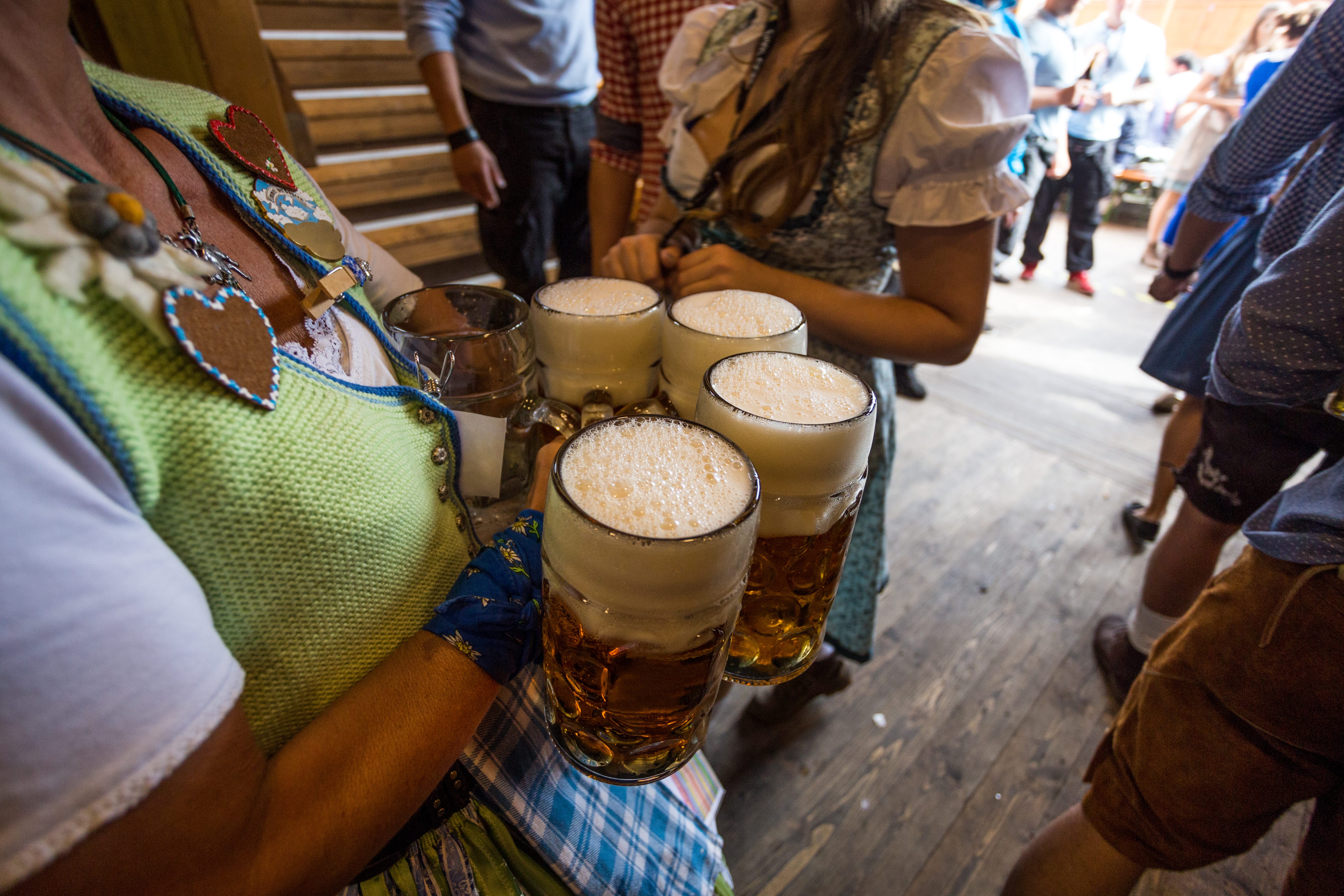 Women holding big mugs of beer at Oktoberfest