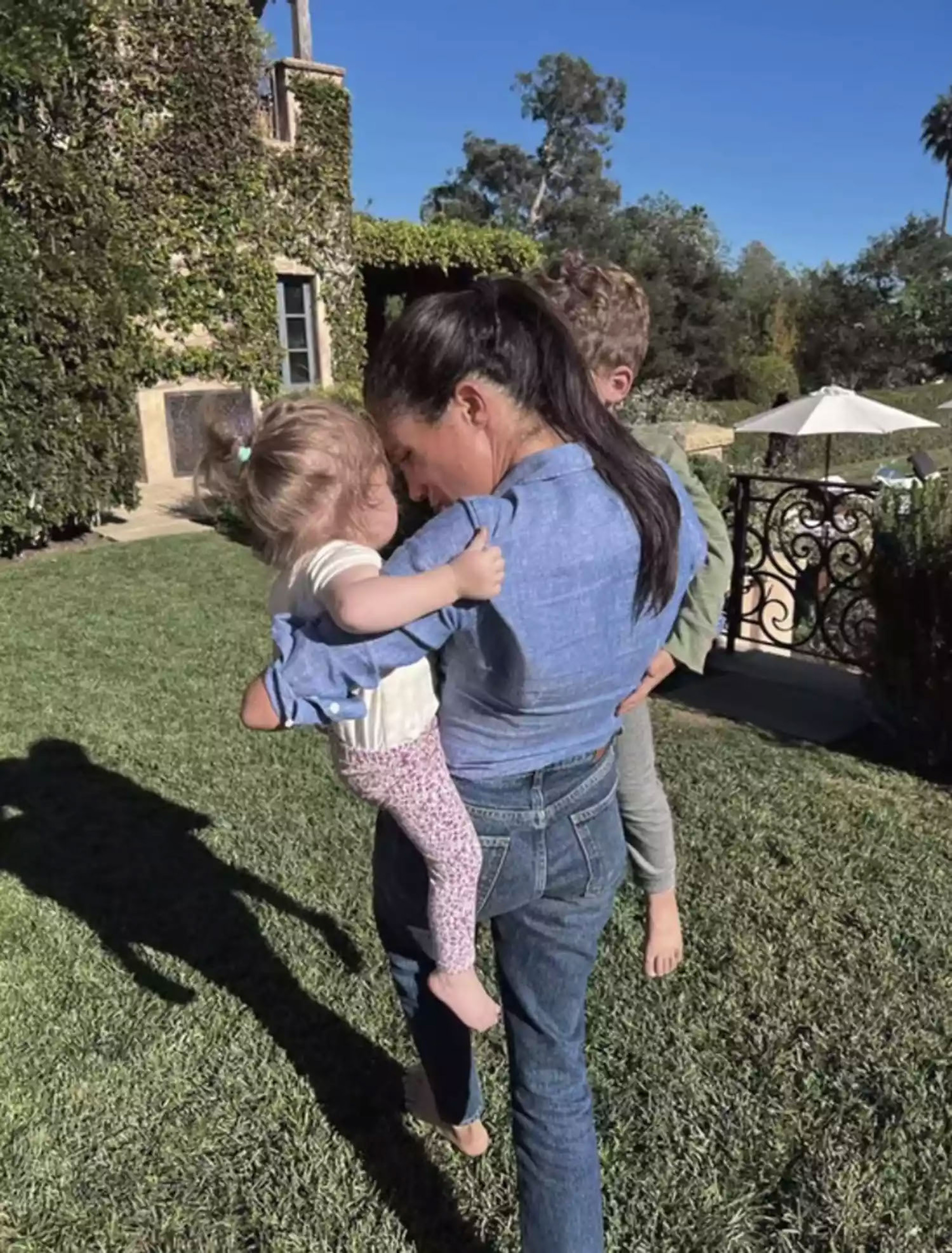 Meghan Markleand her two kids outside.