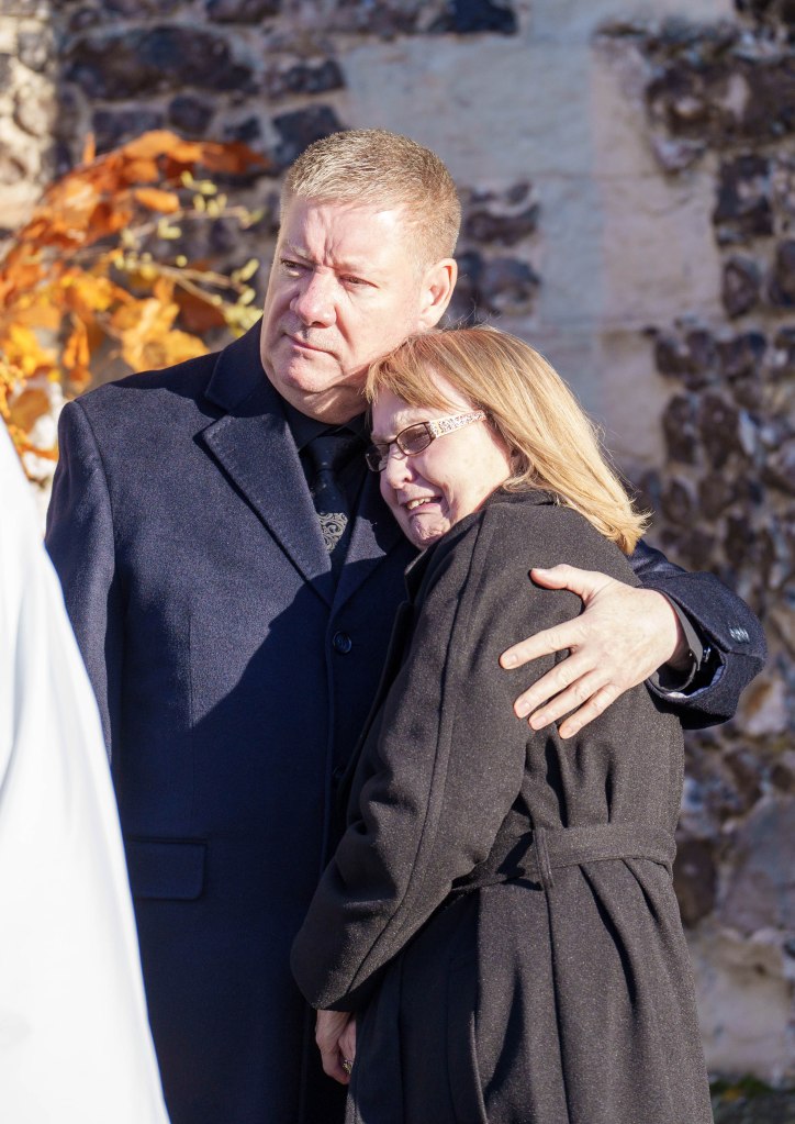 Geoff Payne in a black coat and black shirt, Karen Payne in a black coat.