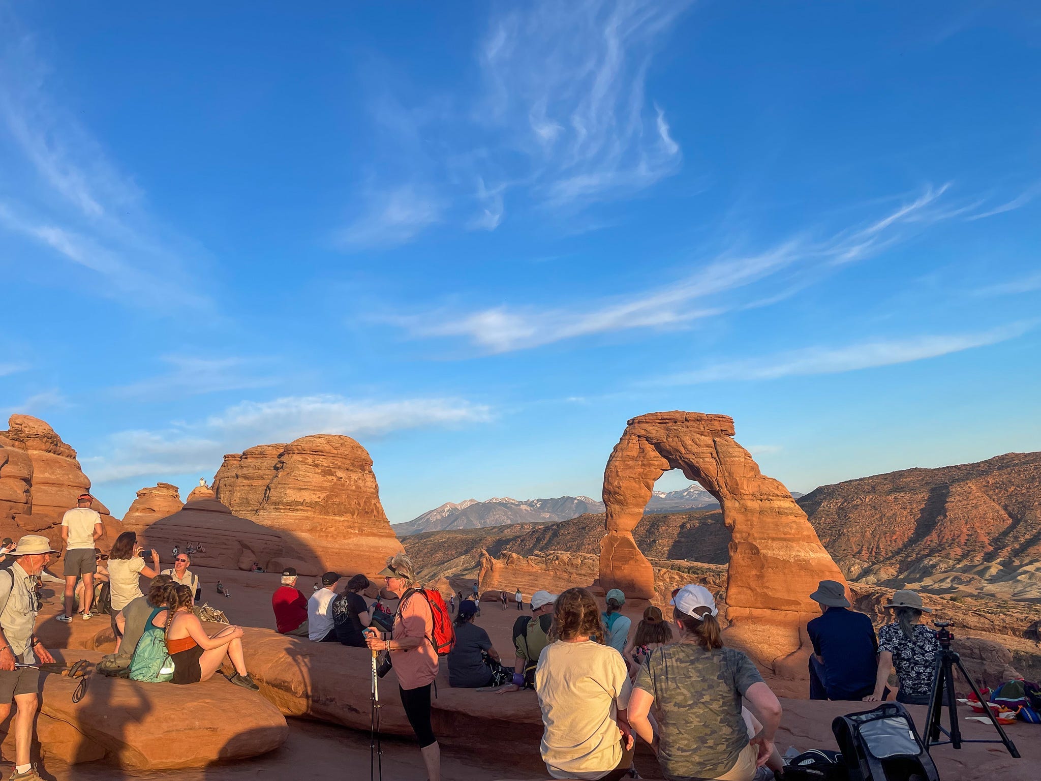Crowds gather to watch the sunset at the Delicate Arch in Arches National Park.