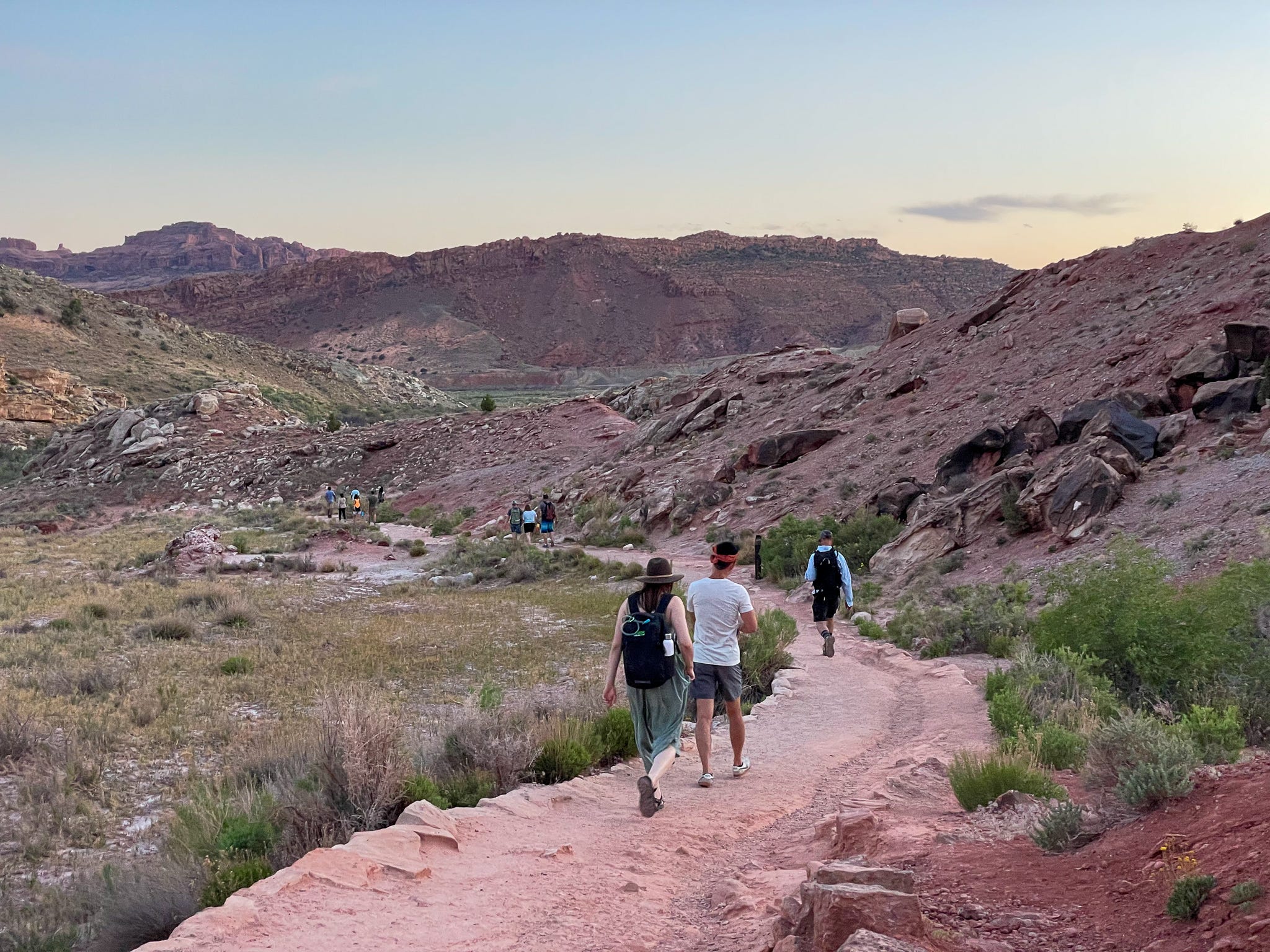 A visitor in Arches National Park carriers water in their backpack.