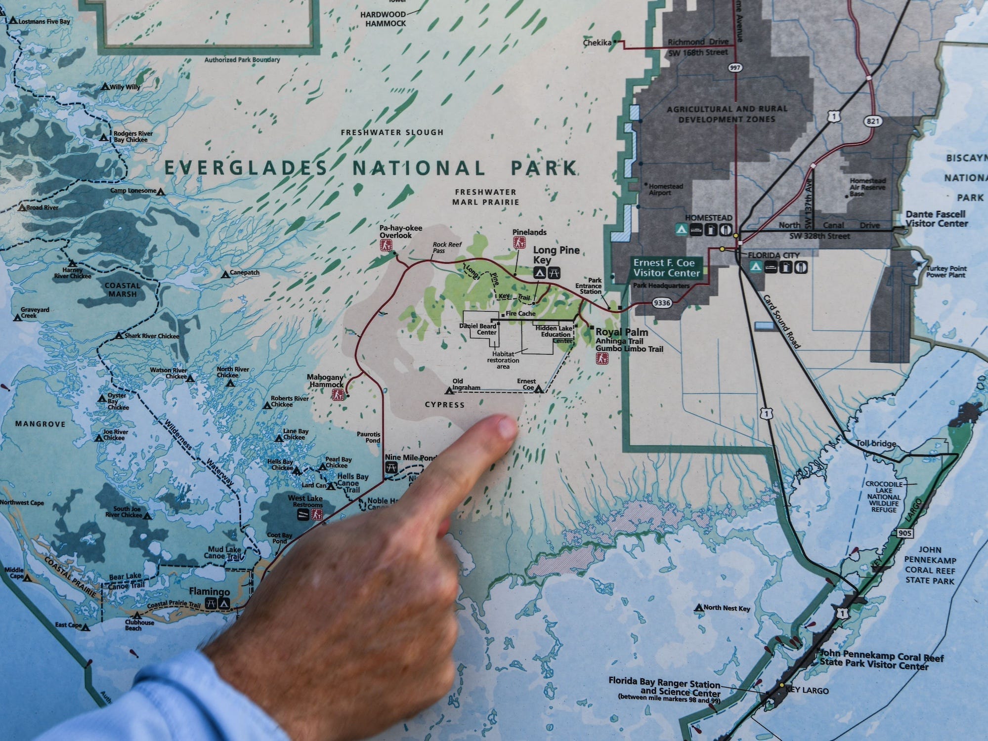 A person points to a map of Everglades National Park in Florida.