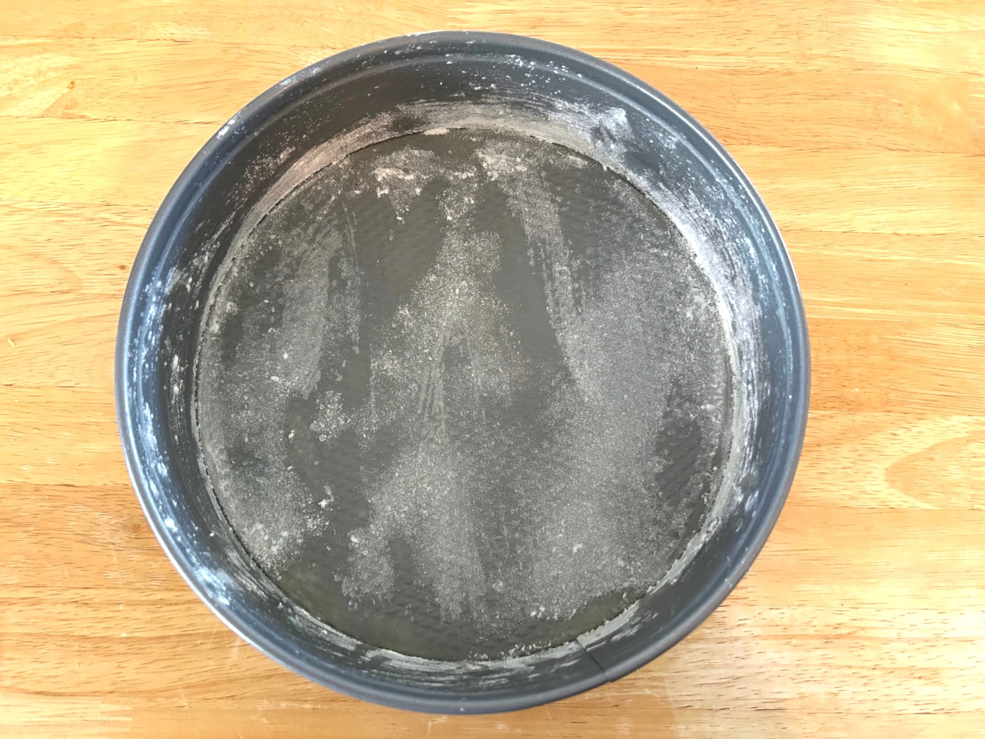 Grease and flouring the Ina Garten's Blueberry Ricotta Breakfast Cake
