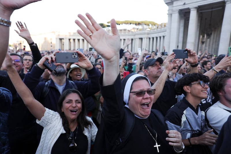 People react as newly elected Pope Leo XIV, Cardinal Robert F. Prevost, appears on the balcony of St. Peter's Basilica at the Vatican, May 8, 2025.