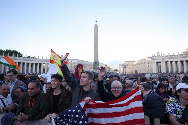Catholics wave an American flag at the Vatican while celebrating the announcement that U.S. Cardinal Robert Prevost was elected pope.