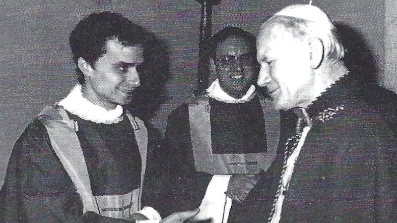 St. Mary of the Assumption Parish included this photo commemorating the 1982 meeting of a newly ordained Robert Prevost and Pope John Paul II in its 1986 book marking its 100th Anniversary.