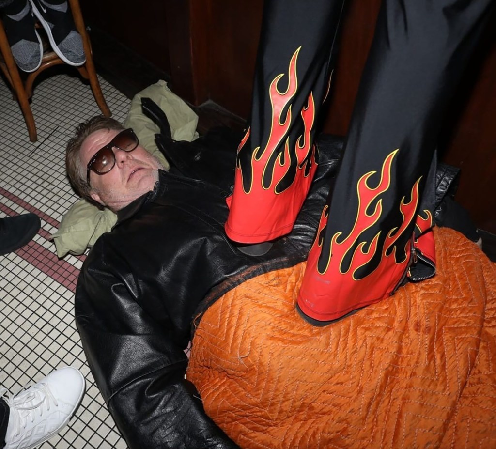 New York City performance artist Kevin Carpet lets people walk over him as he lays down underneath a carpet.