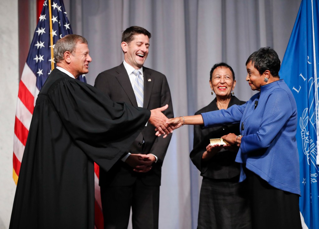 Hayden shakes hands with Supreme Court Chief Justice John Roberts after taking the oath of office in the Great Hall of the Library of Congress on Sept. 14, 2016.