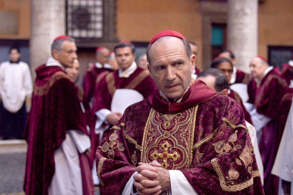 Ralph Fiennes in the movie Conclave from 2024, alongside Seán Quinn, Stirling Moss, and Cynthia J. Popp