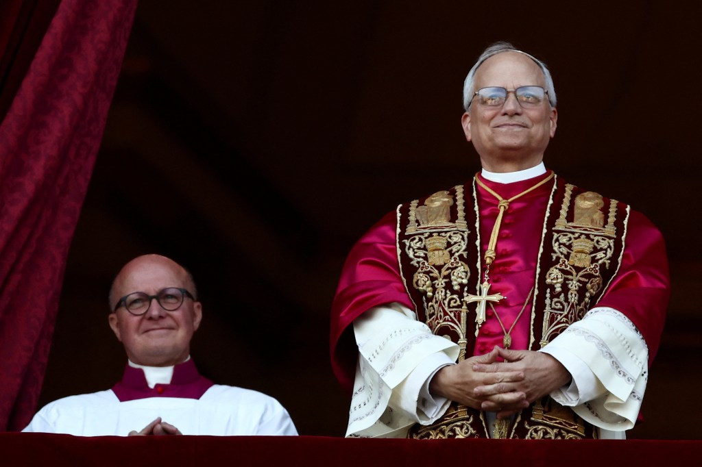 Newly elected Pope Leo XIV, previously known as Cardinal Robert Prevost, greeting crowds from the balcony of St. Peter's Basilica at the Vatican.