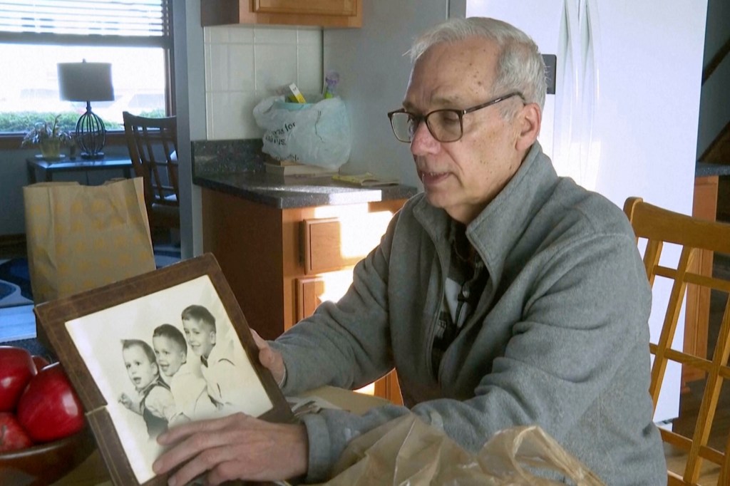 John Prevost points to an old photo of his brothers, including the newly elected Pope Leo XIV (left), during an interview with the Associated Press on May 8, 2025, in New Lennox, Illinois.